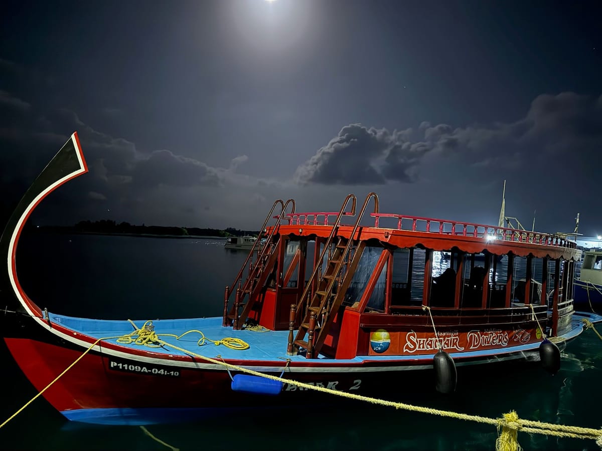 The red dhoni moored in the harbour at night