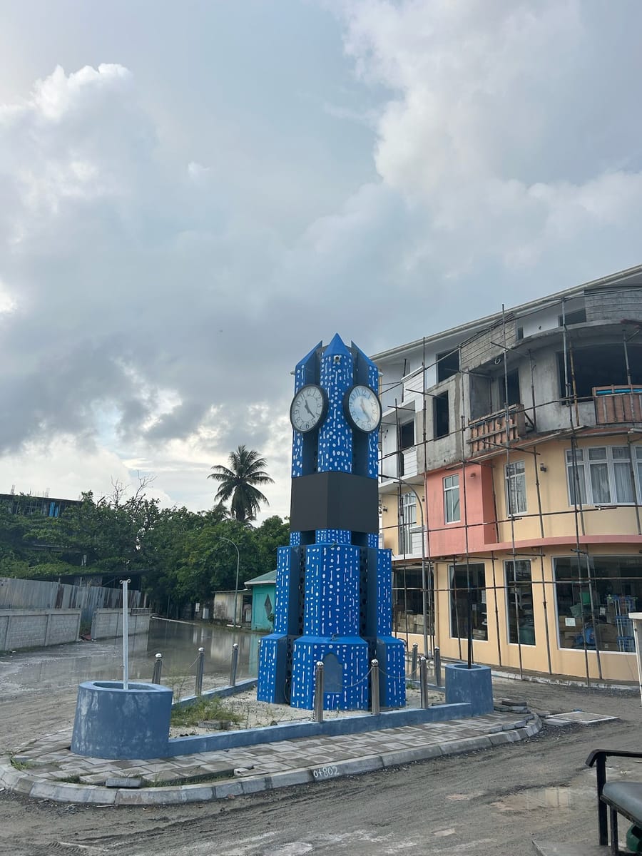 A quiet street on Maamigili with the blue clock tower