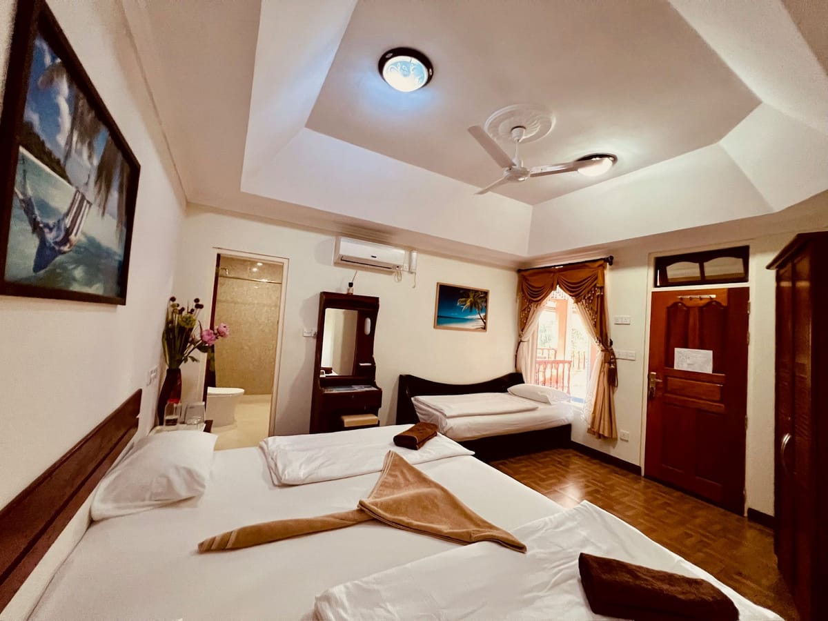 Family room with a double bed and a single bed along the far wall