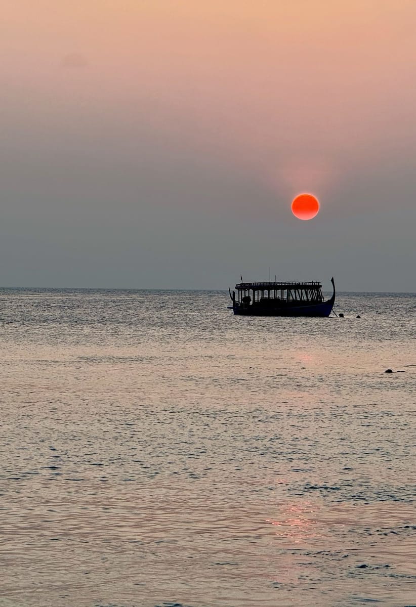 A dhoni against the setting sun